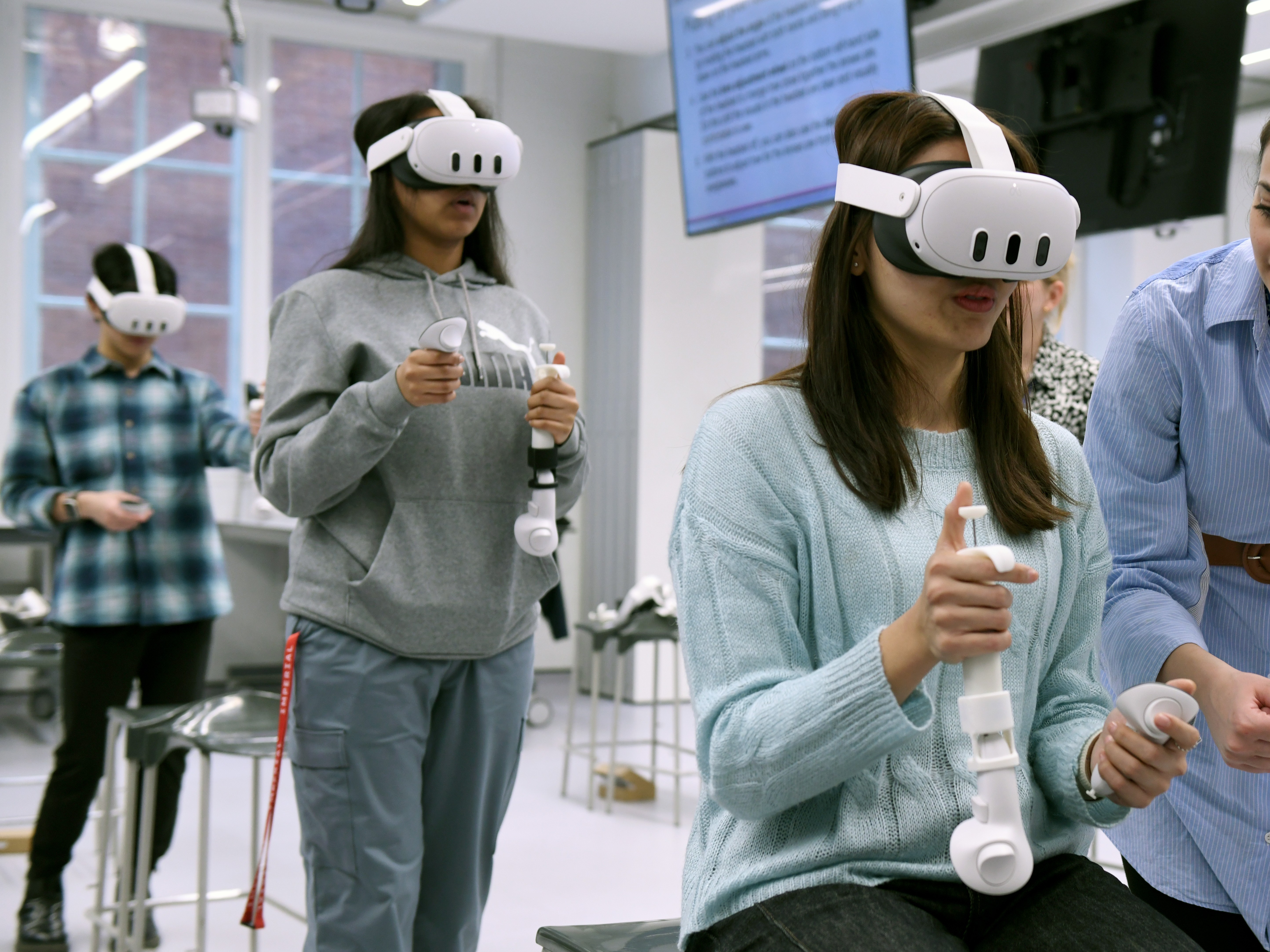Students in headsets using the controllers during a testing session
