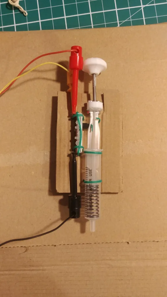 Earliest rig, syringe and spring wired to a board